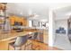 Bright kitchen with stainless steel appliances, light wood cabinets, granite countertops, and an eat-in island at 1030 E 78Th Pl, Denver, CO 80229