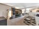 Spacious living room featuring neutral carpets, a built-in entertainment unit, and an open-concept design at 1030 E 78Th Pl, Denver, CO 80229