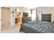 Spacious main bedroom leading to an ensuite bathroom and closet, complete with dark wood furnishings and a serene ambiance at 1030 E 78Th Pl, Denver, CO 80229