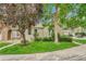 Well-maintained lawn and mature trees surrounding the front of this charming home, enhancing its curb appeal at 1148 S Ventura Cir # H, Aurora, CO 80017