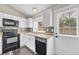 Well-lit kitchen with white cabinets, granite countertops, and stainless-steel appliances at 1148 S Ventura Cir # H, Aurora, CO 80017