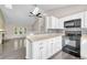 Bright kitchen with granite counters, stainless appliances, and modern ceiling fan at 1148 S Ventura Cir # H, Aurora, CO 80017