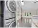 Convenient laundry area with stacked washer and dryer units situated near the living room for easy access at 1148 S Ventura Cir # H, Aurora, CO 80017