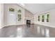 Bright and airy living room with wood floors, a stone fireplace, and large windows that brighten the space at 1148 S Ventura Cir # H, Aurora, CO 80017