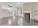 Open-concept living room featuring wood floors, a modern fireplace, and a washer/dryer laundry setup at 1148 S Ventura Cir # H, Aurora, CO 80017