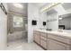 Bathroom featuring a double sink vanity and a tub with a shower at 6888 Howell St, Arvada, CO 80004
