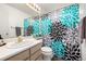 Bathroom with a vanity and a large, bright, floral shower curtain at 6888 Howell St, Arvada, CO 80004