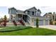 Attractive two-story home with manicured landscaping leading to a two-car attached garage at 6888 Howell St, Arvada, CO 80004