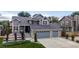 Beautiful two-story home with a two-car garage and a landscaped front yard under a cloudy sky at 6888 Howell St, Arvada, CO 80004