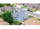 Blue home with a well manicured yard, mature shade tree, and neighborhood street view at 6888 Howell St, Arvada, CO 80004