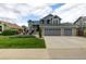Inviting two-story home with a lush front lawn and a spacious two-car garage at 6888 Howell St, Arvada, CO 80004