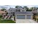 Charming two-story home featuring a well-manicured front yard and an attached two-car garage at 6888 Howell St, Arvada, CO 80004