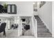 Open entryway showcasing staircase, living space, and dining area with modern decor at 6888 Howell St, Arvada, CO 80004