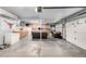 Spacious garage with ample storage cabinets, large freezer, and comfortable seating, perfect for a recreational area at 6888 Howell St, Arvada, CO 80004