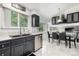 Eat-in kitchen area with bright natural light and a modern chandelier and vaulted ceilings at 6888 Howell St, Arvada, CO 80004