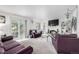 Bright living room featuring a fireplace, TV, chandeliers, and comfortable seating at 6888 Howell St, Arvada, CO 80004