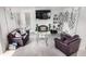 Cozy living room featuring fireplace, TV, stylish decor, and plush seating at 6888 Howell St, Arvada, CO 80004
