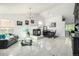 Spacious living room with tile floors, fireplace, dining table, and comfortable seating area at 6888 Howell St, Arvada, CO 80004