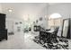 Bright open-plan living and dining area with fireplace, chandeliers and tile floors at 6888 Howell St, Arvada, CO 80004