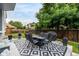 Outdoor patio featuring a modern dining set and grill, perfect for entertaining in a lush, green backyard at 6888 Howell St, Arvada, CO 80004
