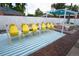 Inviting backyard featuring a dining area with bright yellow chairs and a pergola covered with a blue canopy at 7799 Pecos St, Denver, CO 80221
