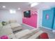 Cozy basement living room with comfortable seating, a modern TV, and playful decor at 7799 Pecos St, Denver, CO 80221