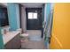 Well-appointed bathroom featuring modern fixtures, blue accent walls, and a tub, offering a comfortable and stylish space at 7799 Pecos St, Denver, CO 80221