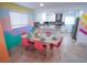 Bright dining area featuring modern decor, a colorful accent wall, and an open flow to the kitchen at 7799 Pecos St, Denver, CO 80221