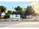 Charming home exterior with a yellow front door, fresh paint, and a quaint wood fence at 7799 Pecos St, Denver, CO 80221
