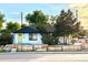 Charming home exterior with a yellow front door, fresh paint, and a quaint wood fence at 7799 Pecos St, Denver, CO 80221