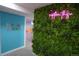 Vibrant hallway featuring a neon sign and a green wall, adding unique character to the home at 7799 Pecos St, Denver, CO 80221