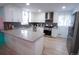 Modern kitchen with stainless steel appliances, bright white cabinetry, and a functional island at 7799 Pecos St, Denver, CO 80221