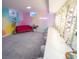 Unique living room featuring a colorful mural, a pink couch, and a vanity area at 7799 Pecos St, Denver, CO 80221