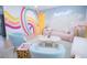 Vibrant living room featuring colorful rainbow wall art, modern furniture, and stylish decor at 7799 Pecos St, Denver, CO 80221