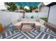 Stylish patio with a comfortable L-shaped sofa, decorative pillows, and a modern coffee table, perfect for outdoor relaxation at 7799 Pecos St, Denver, CO 80221