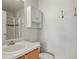 Bathroom features shower, cabinet, sink, and toilet at 5779 Ceylon St, Denver, CO 80249