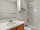 Bathroom features shower and bathtub combination, cabinet, sink, and toilet at 5779 Ceylon St, Denver, CO 80249