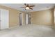 A bedroom offers carpet flooring, ceiling fan, and access to closet and bedroom at 5779 Ceylon St, Denver, CO 80249