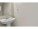 Powder room with a pedestal sink and chrome fixtures at 5779 Ceylon St, Denver, CO 80249