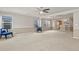 Spacious living room with neutral walls and adjacent kitchen with breakfast bar at 5779 Ceylon St, Denver, CO 80249