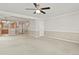 Open-concept living room with neutral carpet, fan and access to the kitchen at 5779 Ceylon St, Denver, CO 80249