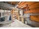 Unfinished basement area showing exposed ceiling and support beams, with potential for storage and a workbench at 10525 Hobbit Ln, Westminster, CO 80031