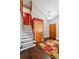 Inviting entryway featuring hardwood floors, colorful rug, staircase and access to various rooms at 10525 Hobbit Ln, Westminster, CO 80031