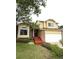 Inviting two-story home with a well-maintained front yard, attached two-car garage, and charming red brick accents at 10525 Hobbit Ln, Westminster, CO 80031