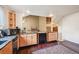 Bright kitchen with hardwood floors, granite countertops, stainless steel appliances and custom wood cabinets at 10525 Hobbit Ln, Westminster, CO 80031