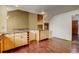 Bright kitchen featuring hardwood floors, granite countertops, custom wood cabinets at 10525 Hobbit Ln, Westminster, CO 80031