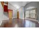 Spacious living room with hardwood floors, vaulted ceilings, and ample natural light from the large window at 10525 Hobbit Ln, Westminster, CO 80031
