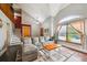 Bright living room with vaulted ceiling, hardwood floors, large windows, and a cozy sectional sofa at 10525 Hobbit Ln, Westminster, CO 80031