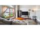 Cozy living room features ample light, wood floors, a large sectional, and decorative elements at 10525 Hobbit Ln, Westminster, CO 80031