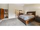 Bright bedroom featuring plush carpet, a bed, and ensuite access at 10525 Hobbit Ln, Westminster, CO 80031